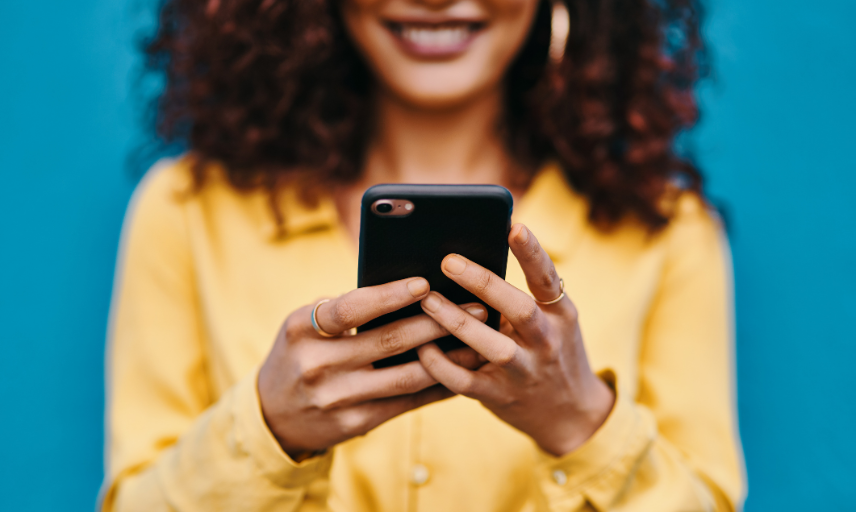 Lady holding phone and smiling