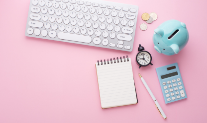 Desk with keyboard piggy bank, clock and calculator