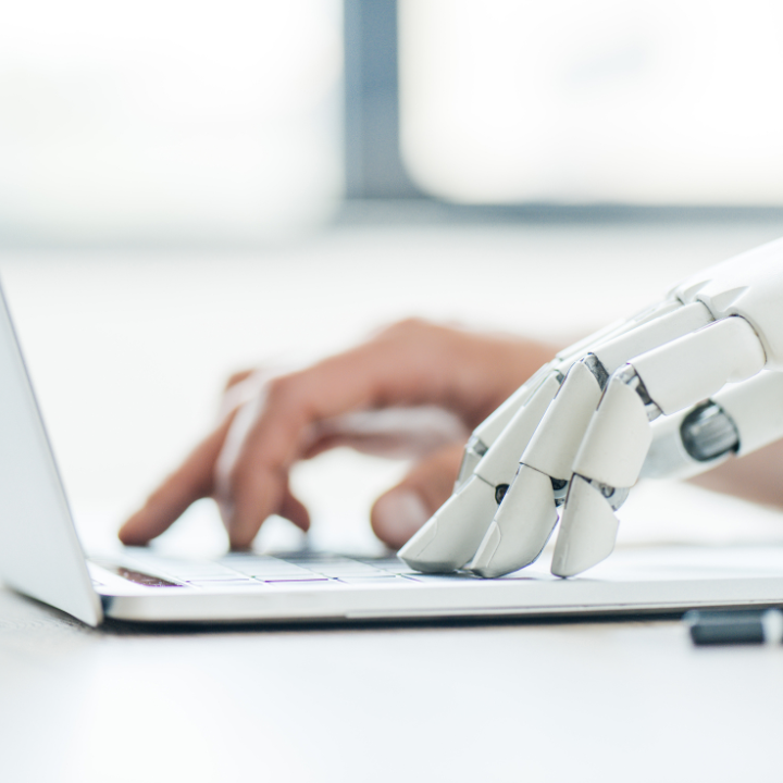 Computer with one human hand and one robotic hand