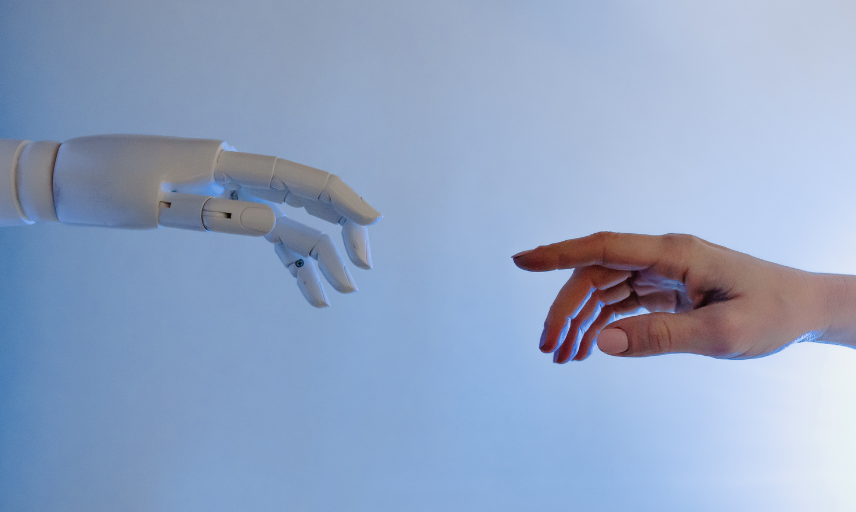 Human hand and robotic hand reaching to touch